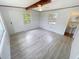 Spacious bedroom with wainscotting, wood beam, ceiling fan, and ample natural light at 4722 Harris Ave, Sarasota, FL 34233