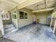 Covered carport entrance featuring concrete flooring, lighting and an entrance to the home at 4722 Harris Ave, Sarasota, FL 34233