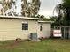 Exterior shot showing the home with neutral siding and a large grassy backyard at 4722 Harris Ave, Sarasota, FL 34233