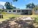 Charming single-story home with a covered carport, gray exterior, and well-maintained lawn at 4722 Harris Ave, Sarasota, FL 34233