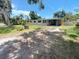 Charming single-story home with a well-maintained lawn, mature trees, and a partial driveway at 4722 Harris Ave, Sarasota, FL 34233