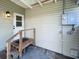 Outdoor entry area with wooden steps, side door, and utility connections at 4722 Harris Ave, Sarasota, FL 34233