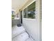 Inviting front entrance with a storm door, concrete steps, and neutral siding, a tidy approach at 4722 Harris Ave, Sarasota, FL 34233