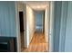A long hallway features hardwood floors and access to multiple rooms at 4722 Harris Ave, Sarasota, FL 34233