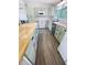 Spacious kitchen featuring white appliances, butcher block countertops, and light blue cabinets at 4722 Harris Ave, Sarasota, FL 34233