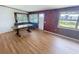 Bright living room with wood-look floors, wood-paneled wall, and custom-built table at 4722 Harris Ave, Sarasota, FL 34233