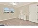 Simple bedroom with a white dresser, wood-look floors, and a large window allowing lots of natural light at 5501 80Th N St # 206, St Petersburg, FL 33709