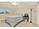 Comfortable bedroom with a ceiling fan, a full bed with blue floral comforter, and a vanity at 5501 80Th N St # 206, St Petersburg, FL 33709