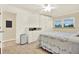 Bedroom featuring white wood flooring, a full bed, built in storage, and a window at 5501 80Th N St # 206, St Petersburg, FL 33709