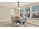 Cozy dining area featuring a wood table, four chairs, tile floors, and natural light from the window at 5501 80Th N St # 206, St Petersburg, FL 33709