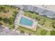 Aerial view of a community pool surrounded by palm trees and lounge chairs, perfect for relaxation at 5501 80Th N St # 206, St Petersburg, FL 33709