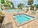 Spa and pool area featuring a hot tub and swimming pool, perfect for relaxation and enjoying the outdoors at 5501 80Th N St # 206, St Petersburg, FL 33709