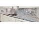 A kitchen sink with granite countertops and gray patterned backsplash at 5501 80Th N St # 206, St Petersburg, FL 33709