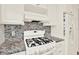 The stove is clean and features a modern range hood above it at 5501 80Th N St # 206, St Petersburg, FL 33709