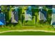 An overhead perspective of a fenced yard, a fire pit and mature trees, close to a pond at 5624 Fisher Glen Loop, Wesley Chapel, FL 33545