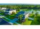 Beautiful aerial view of a home with a large backyard, a green lawn and a tranquil lake nearby at 5624 Fisher Glen Loop, Wesley Chapel, FL 33545