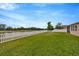 Backyard features a view of the pond and a well-kept lawn at 5624 Fisher Glen Loop, Wesley Chapel, FL 33545