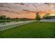 Peaceful backyard overlooking a tranquil lake, complete with a cozy fire pit and lush green lawn at 5624 Fisher Glen Loop, Wesley Chapel, FL 33545