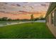 Enjoy this oversized backyard with a serene lake view and stone fire pit, perfect for entertaining at 5624 Fisher Glen Loop, Wesley Chapel, FL 33545