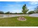 Backyard features a charming fire pit and white picket fence at 5624 Fisher Glen Loop, Wesley Chapel, FL 33545