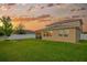 Expansive backyard with a screened porch and stone fire pit offering plenty of space for outdoor activities at 5624 Fisher Glen Loop, Wesley Chapel, FL 33545