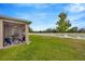 Relaxing screened-in porch and spacious backyard with a charming fire pit and a scenic water view at 5624 Fisher Glen Loop, Wesley Chapel, FL 33545