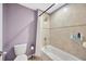 Bathroom featuring a shower and tub combination with tiled wall and a toilet at 5624 Fisher Glen Loop, Wesley Chapel, FL 33545