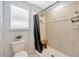 Shower featuring tiled walls, shower head, a wooden bench and a toilet at 5624 Fisher Glen Loop, Wesley Chapel, FL 33545