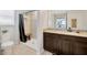 Bathroom featuring vanity and granite countertop plus a toilet and walk in shower at 5624 Fisher Glen Loop, Wesley Chapel, FL 33545