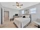 Bedroom with carpet and ceiling fan plus a view into the hallway at 5624 Fisher Glen Loop, Wesley Chapel, FL 33545