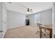 Bedroom features a ceiling fan and a functional workspace at 5624 Fisher Glen Loop, Wesley Chapel, FL 33545