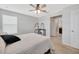 Bedroom with carpet flooring and ceiling fan plus a view into the bathroom at 5624 Fisher Glen Loop, Wesley Chapel, FL 33545