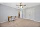 Spacious bedroom with a ceiling fan and plush carpeting at 5624 Fisher Glen Loop, Wesley Chapel, FL 33545