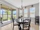 Cozy dining area with sliding glass doors to the backyard and an elegant chandelier at 5624 Fisher Glen Loop, Wesley Chapel, FL 33545