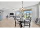 Open-concept dining area with views of the living room and access to the backyard at 5624 Fisher Glen Loop, Wesley Chapel, FL 33545