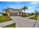 Charming two-story home featuring a well-manicured lawn, a two car garage, and a cozy front porch at 5624 Fisher Glen Loop, Wesley Chapel, FL 33545