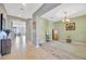 Bright foyer with tile and wood-look floors, and a decorative rug creating a welcoming entrance at 5624 Fisher Glen Loop, Wesley Chapel, FL 33545