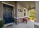 Inviting front porch with a cozy bench, elegant decor, and a charming door wreath for a welcoming entrance at 5624 Fisher Glen Loop, Wesley Chapel, FL 33545