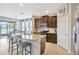 Eat-in kitchen featuring an island with bar stools and stainless steel appliances at 5624 Fisher Glen Loop, Wesley Chapel, FL 33545
