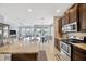 Open kitchen with stainless steel appliances, granite countertops, and dark wood cabinetry at 5624 Fisher Glen Loop, Wesley Chapel, FL 33545