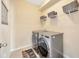 Efficient laundry room featuring modern appliances and ample storage space at 5624 Fisher Glen Loop, Wesley Chapel, FL 33545