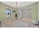Inviting living room with a decorative chandelier, neutral rug, and large window at 5624 Fisher Glen Loop, Wesley Chapel, FL 33545