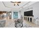 Spacious living room with a ceiling fan, entertainment center, and decorative furniture at 5624 Fisher Glen Loop, Wesley Chapel, FL 33545