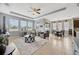 Spacious living room with large windows, ceiling fan, and stylish decor at 5624 Fisher Glen Loop, Wesley Chapel, FL 33545