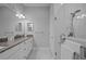 Bathroom featuring dual sinks with granite countertop and a frameless glass shower with chrome fixtures at 5742 Stockport St, Riverview, FL 33578