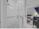 Modern bathroom with a frameless glass shower, white tiled walls, and a view into the bedroom at 5742 Stockport St, Riverview, FL 33578