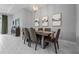 Elegant dining room featuring modern lighting fixture, stylish artwork, and a table set for six at 5742 Stockport St, Riverview, FL 33578
