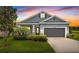 Charming single-Gathering home featuring well-manicured lawn and a two-car garage under colorful sky at 5742 Stockport St, Riverview, FL 33578