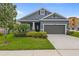Charming single-Gathering home featuring well-manicured lawn and a two-car garage on a sunny day at 5742 Stockport St, Riverview, FL 33578