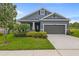 Charming single-story home with blue siding, a well-manicured lawn, and a two-car garage at 5742 Stockport St, Riverview, FL 33578